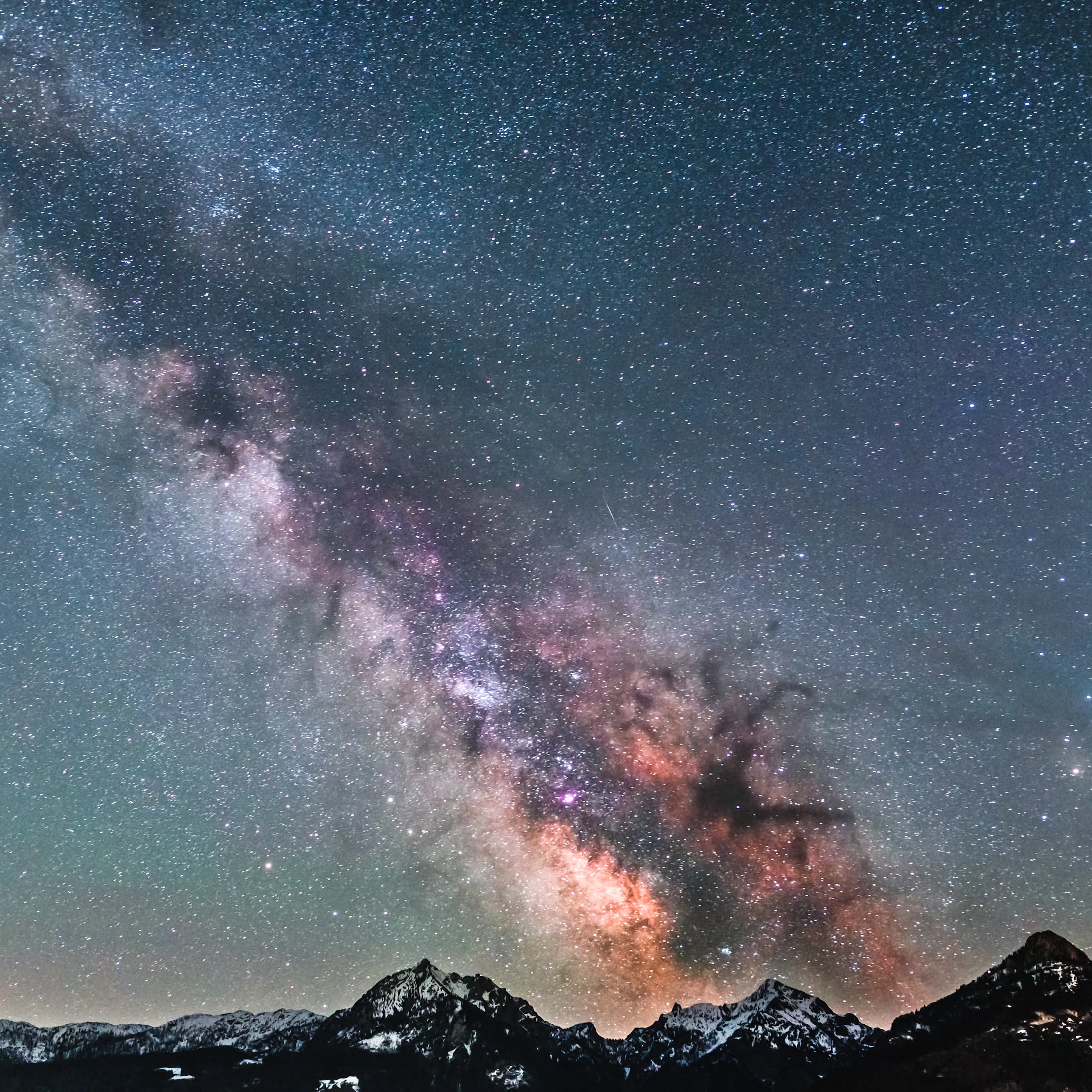 An alpine landscape under a star-filled sky